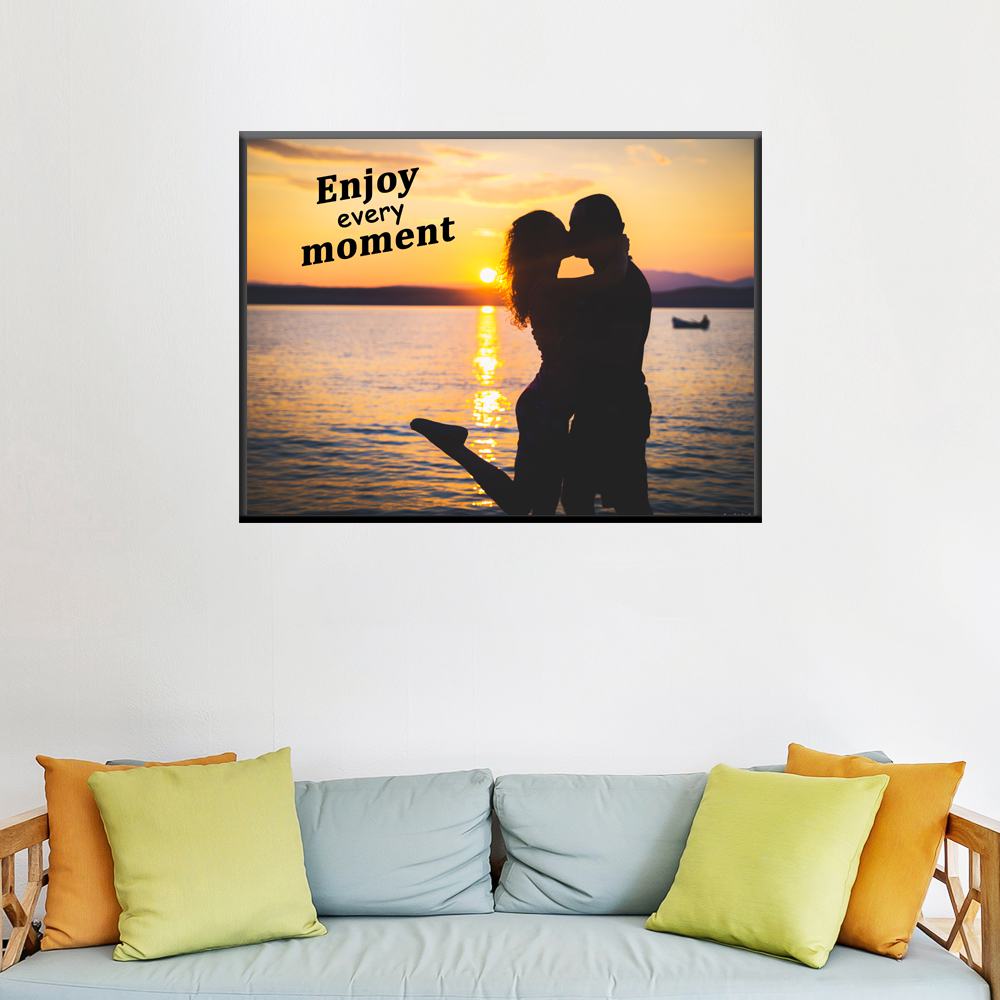 Enjoy every moment text with Couple kissing at sunset